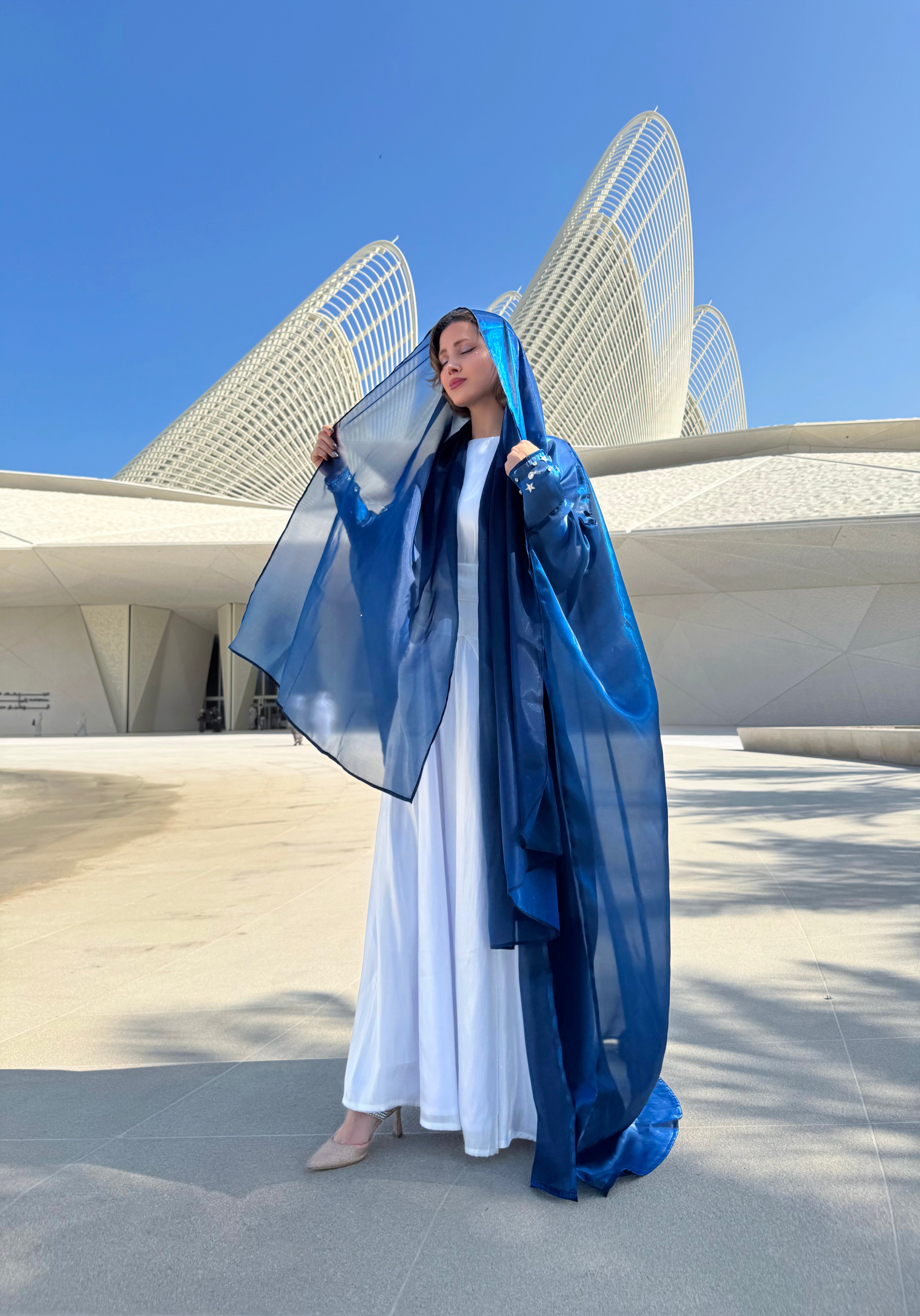 Blue organza Abaya with a white Dress